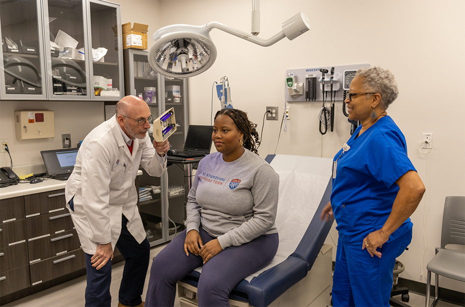 Dr. Heine helping a student at the health center