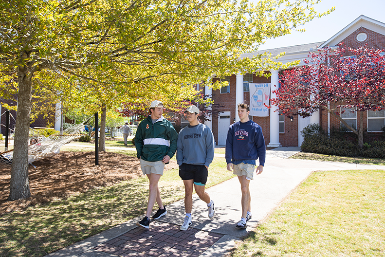 Students walking outside of village 