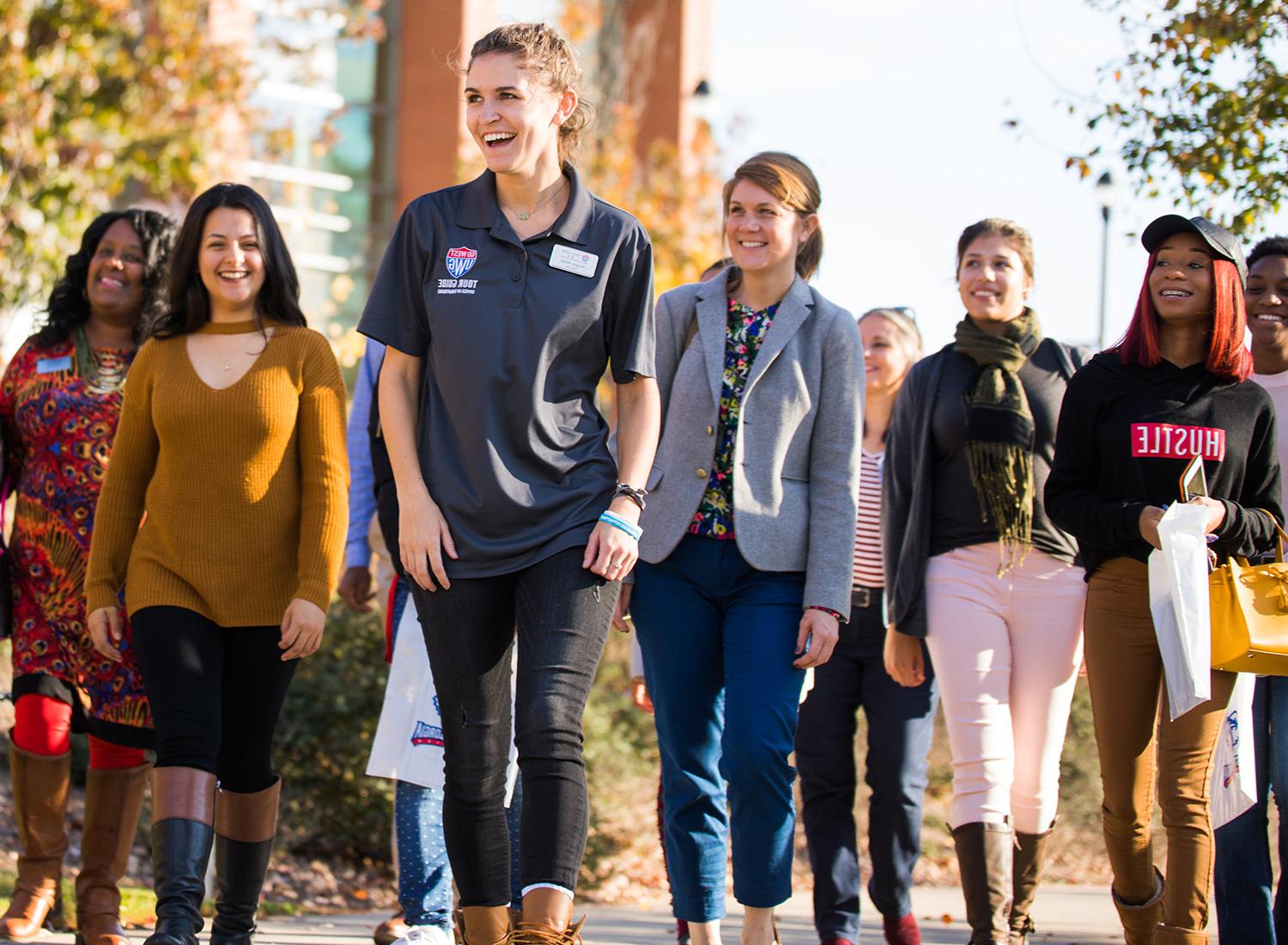 campus tour guide leading a group in front of the Campus Center